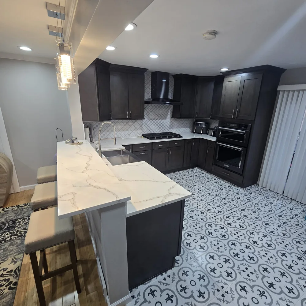 Kitchen after the RuLee Construction remodel — new cabinetry, counters, and finishes