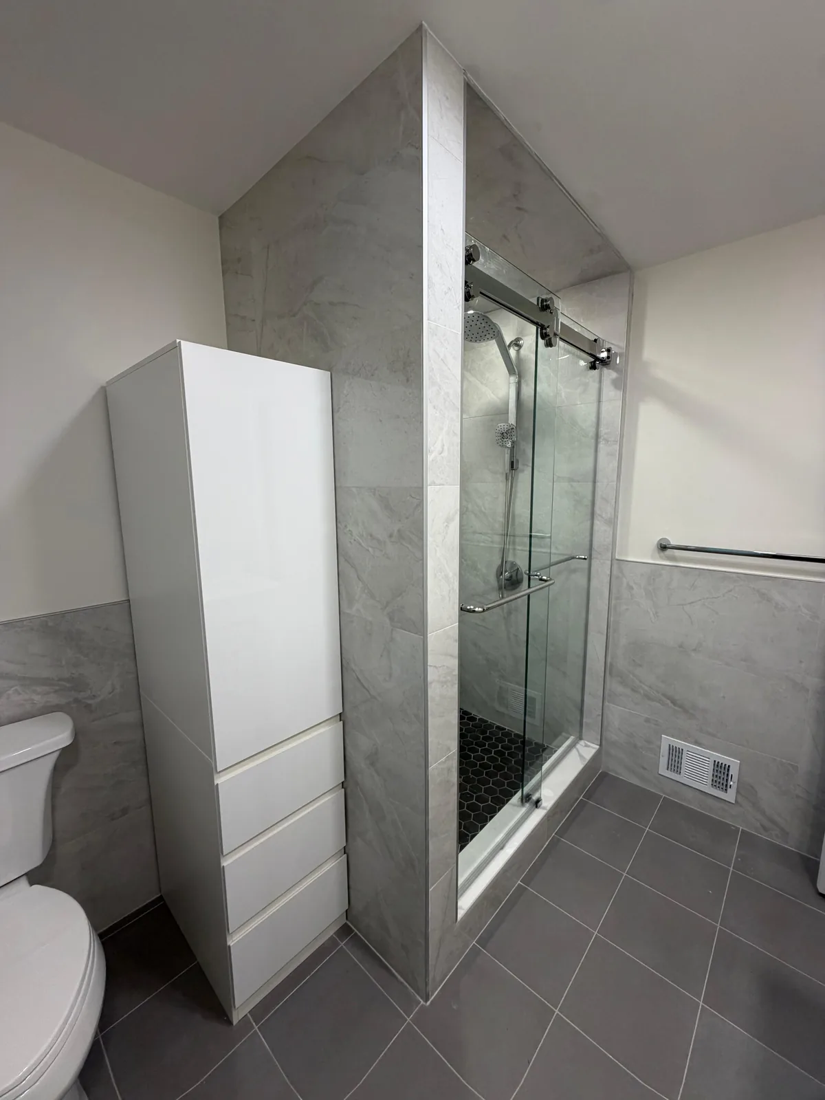 Gray-tile shower, sliding glass