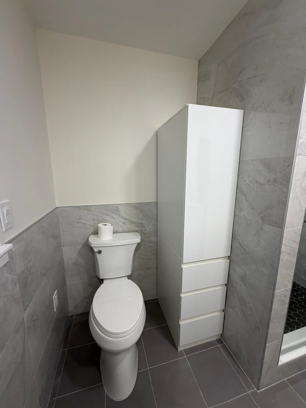 Toilet area, white storage tower