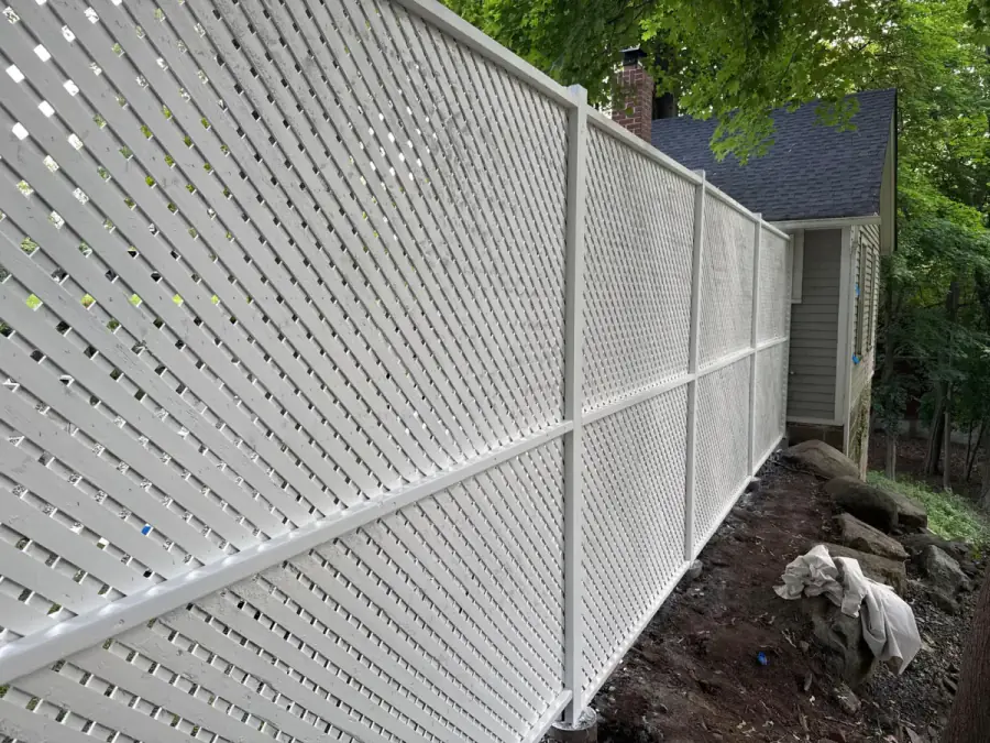 White lattice fence, house behind