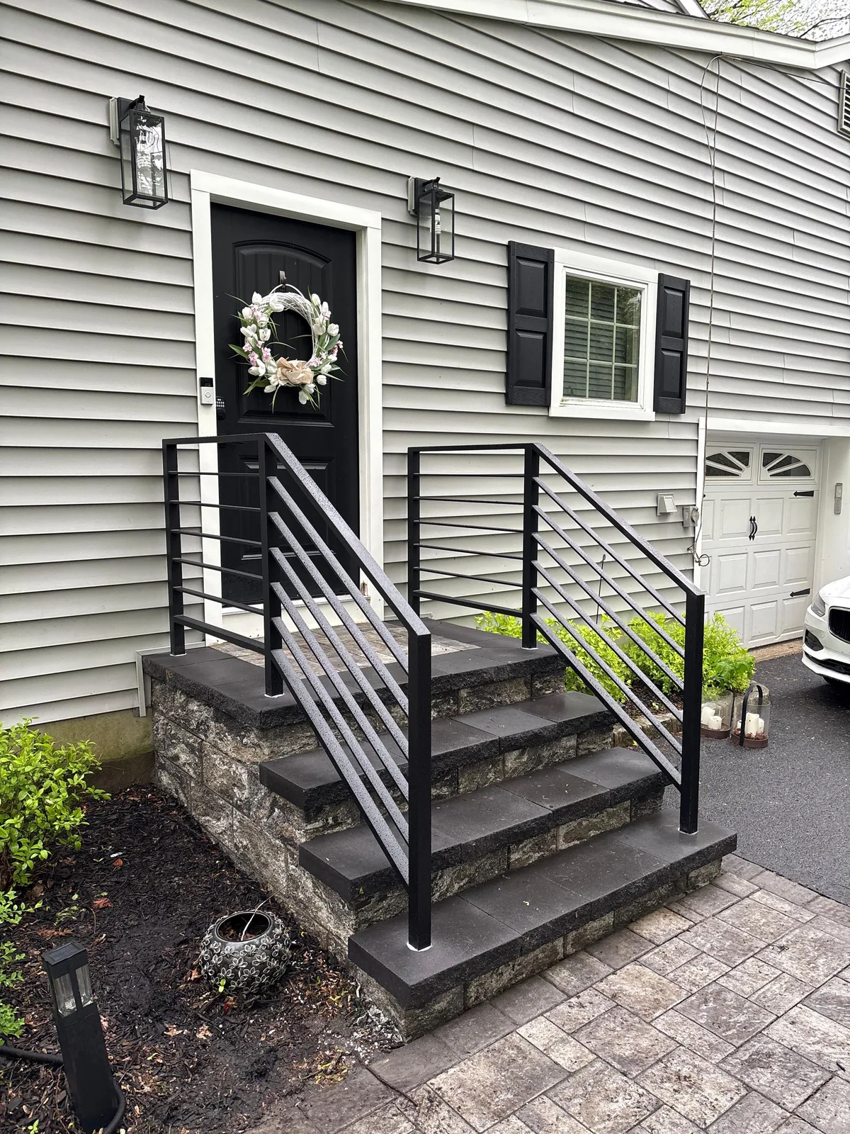 Entry stoop, black rail and door