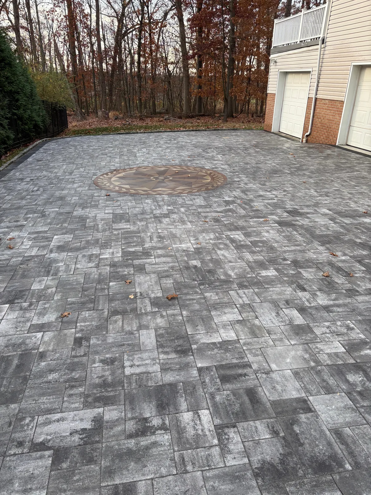 Gray paver driveway with medallion
